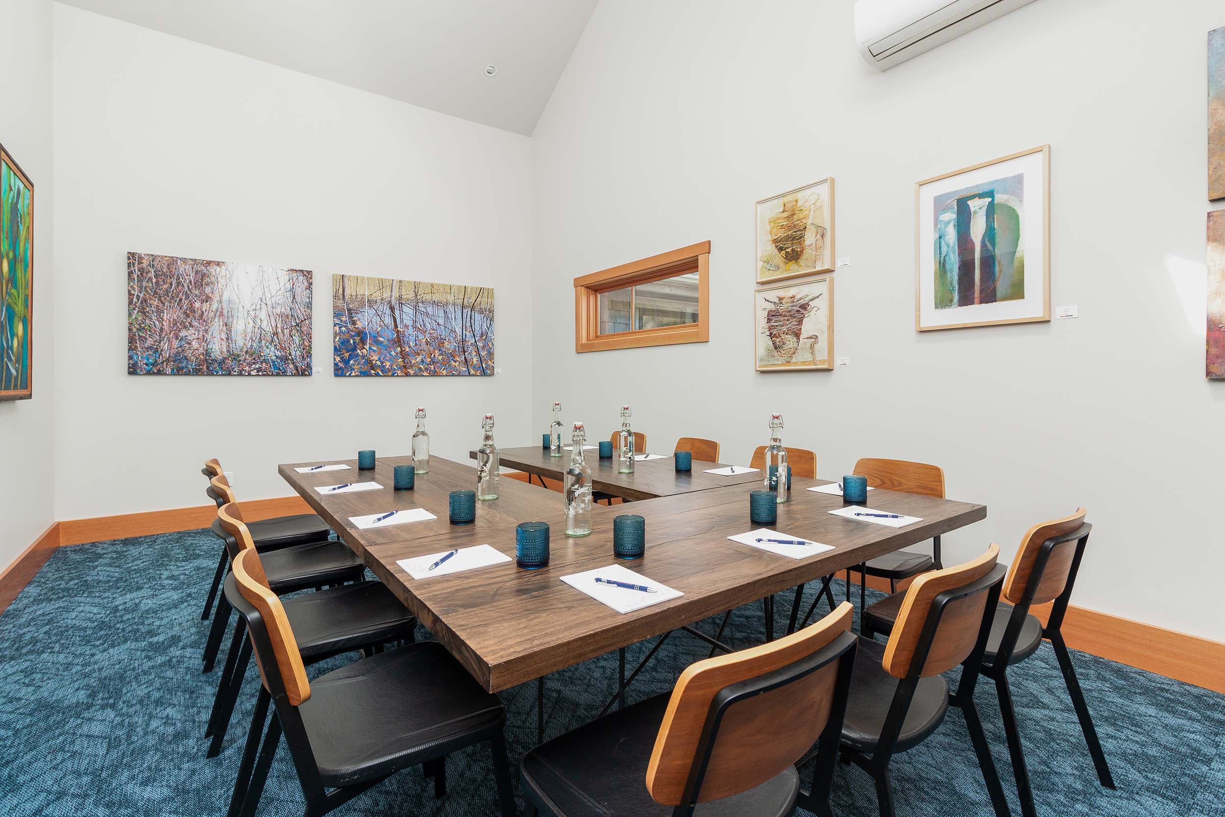 Table setup in a U-shape in the Compass room at Headlands