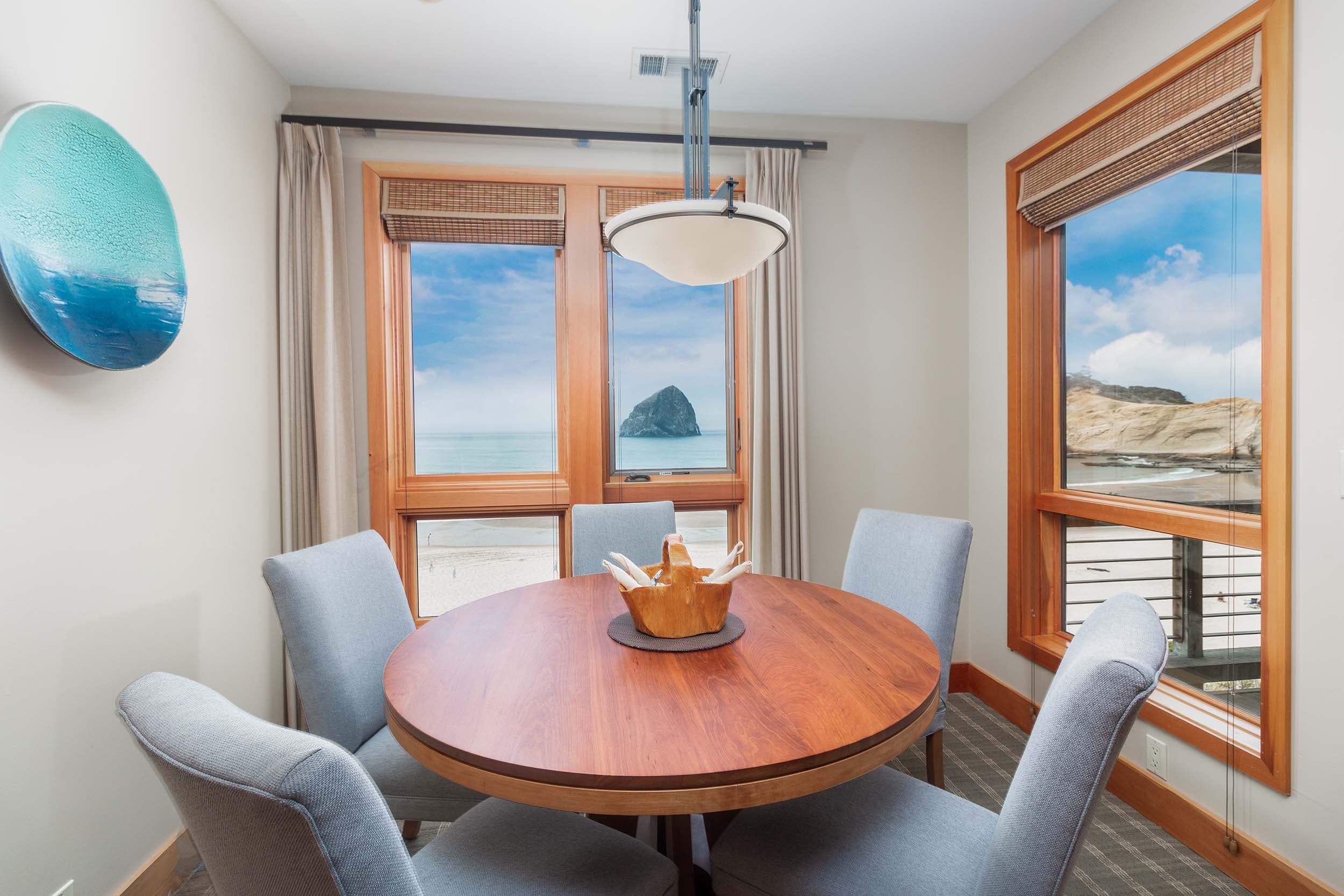 A dining table with 5 chairs in a 2 bedroom cottage at Headlands