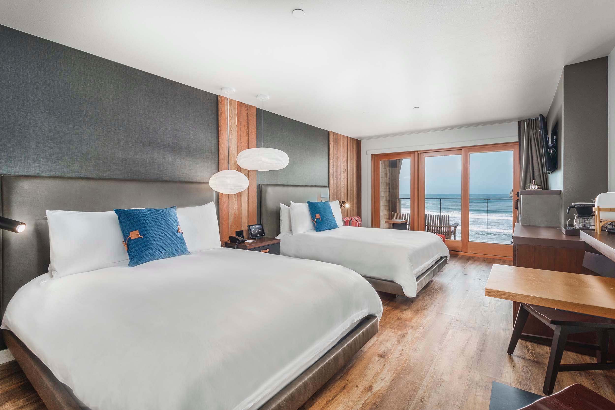 Interior sleeping arrangements of a two queen signature bedroom at Headlands Lodge