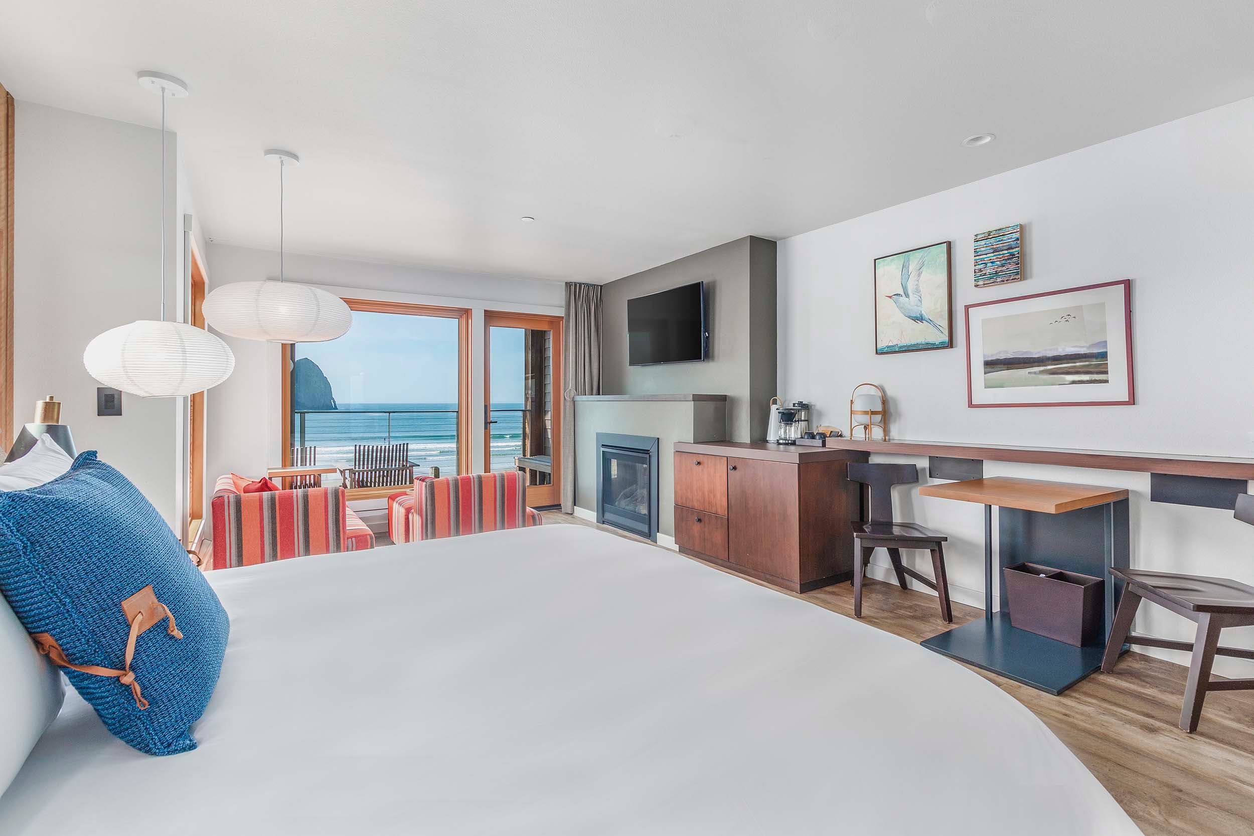 Interior sleeping arrangements of a Kings signature accessible suite looking out at the ocean at Headlands Lodge