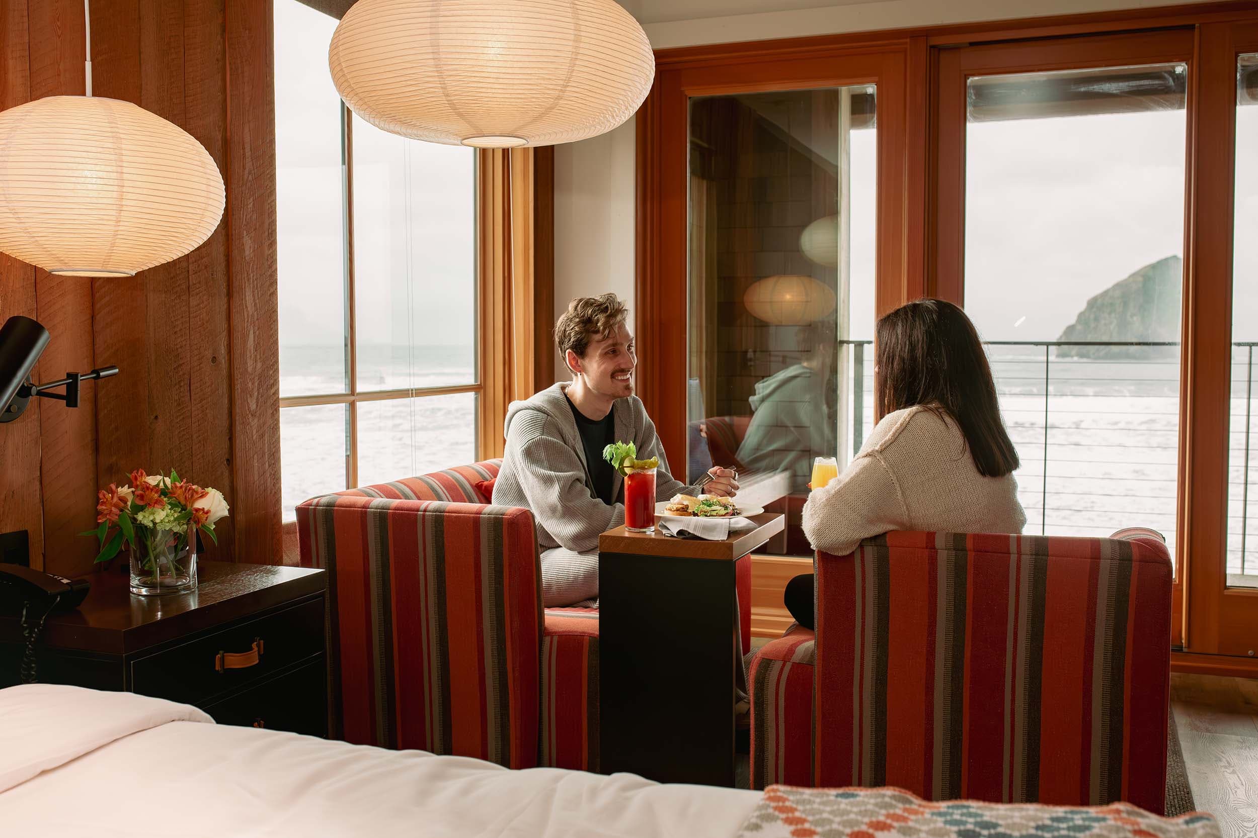 A couple having food in their room at headlands