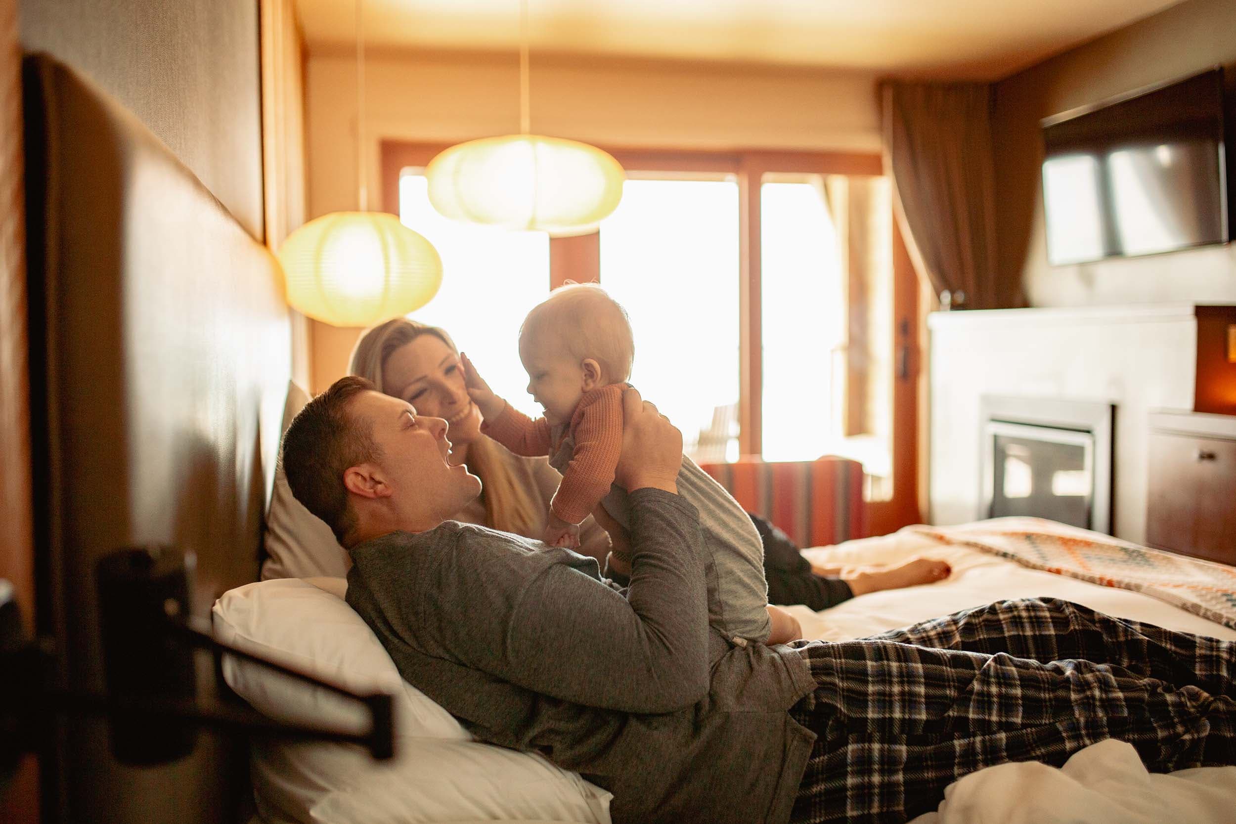 A family in bed int heir room at Headlands