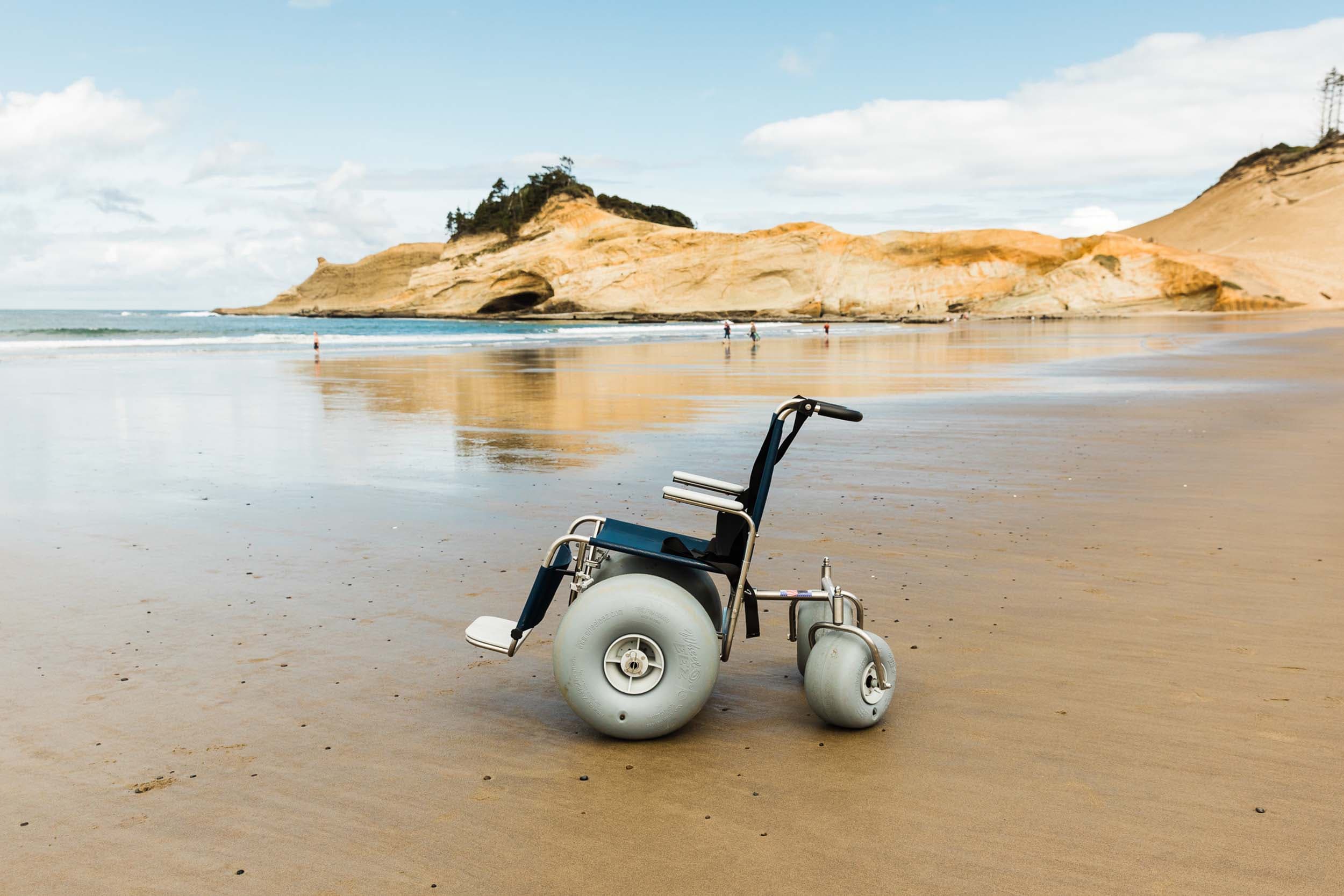 A wheelchair with large wheels on the beach at Cape Kiwanda