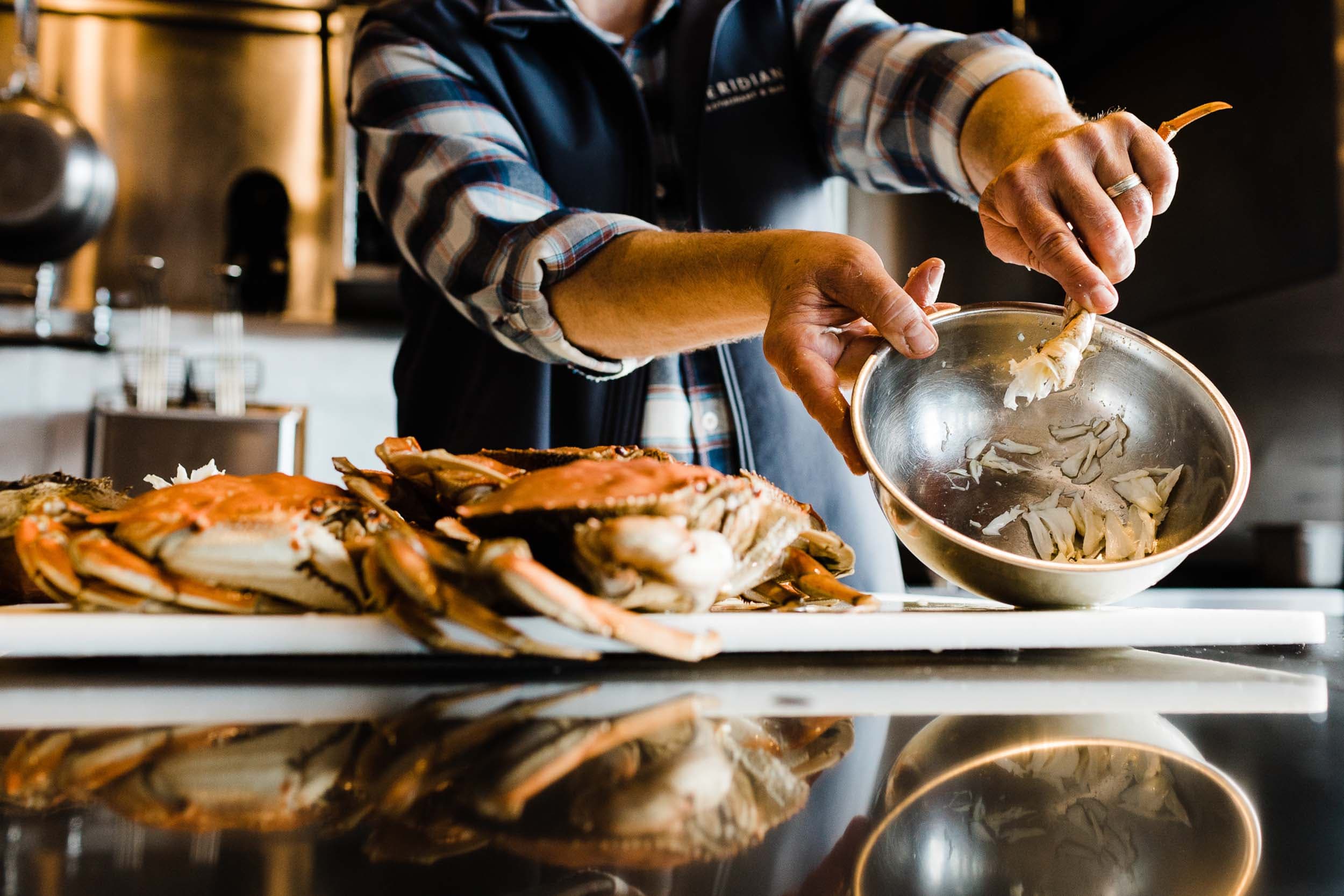 A chef breaking down crabs to get the crab meat at Headlands