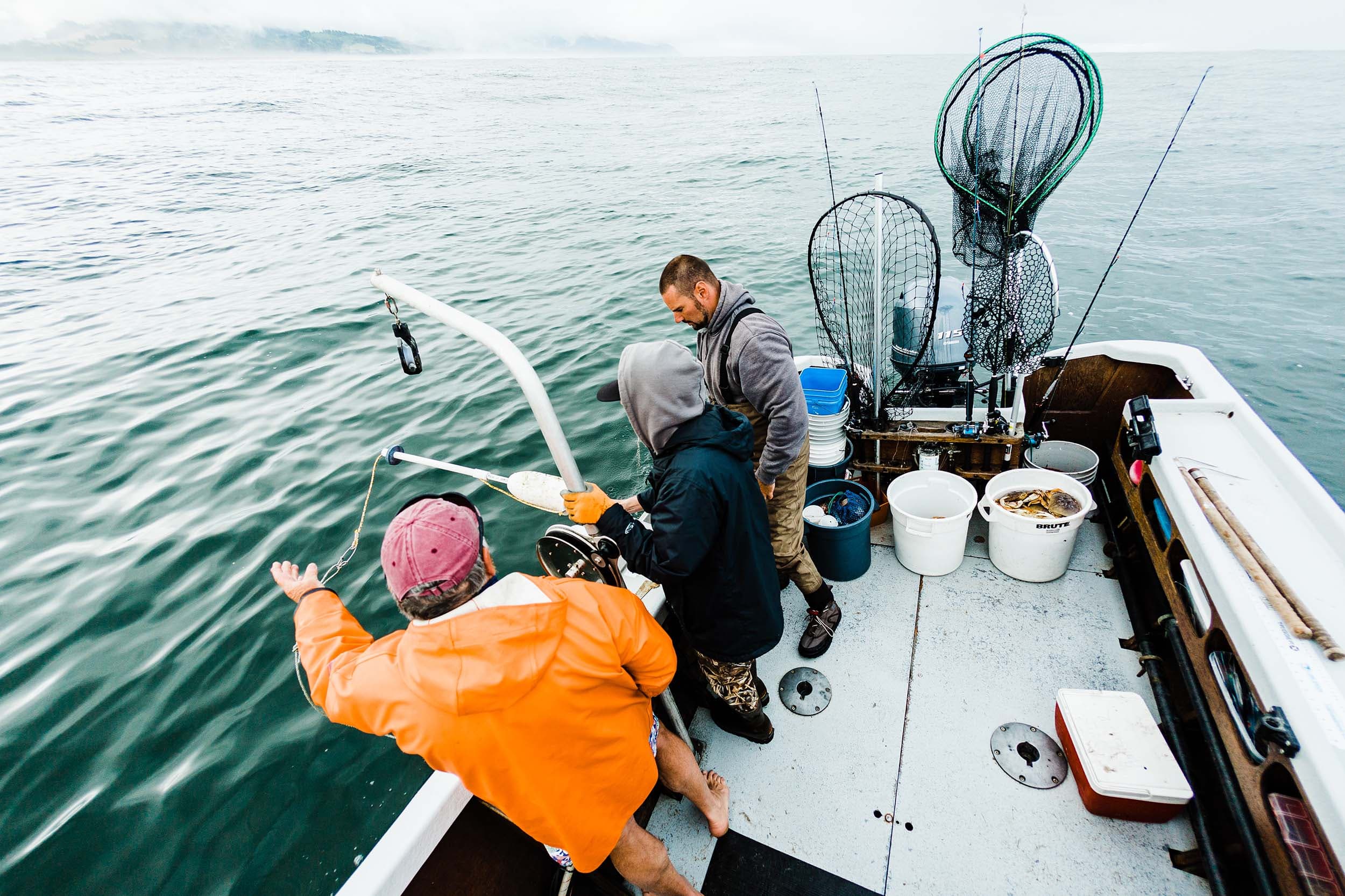 3 people on a fishing boat