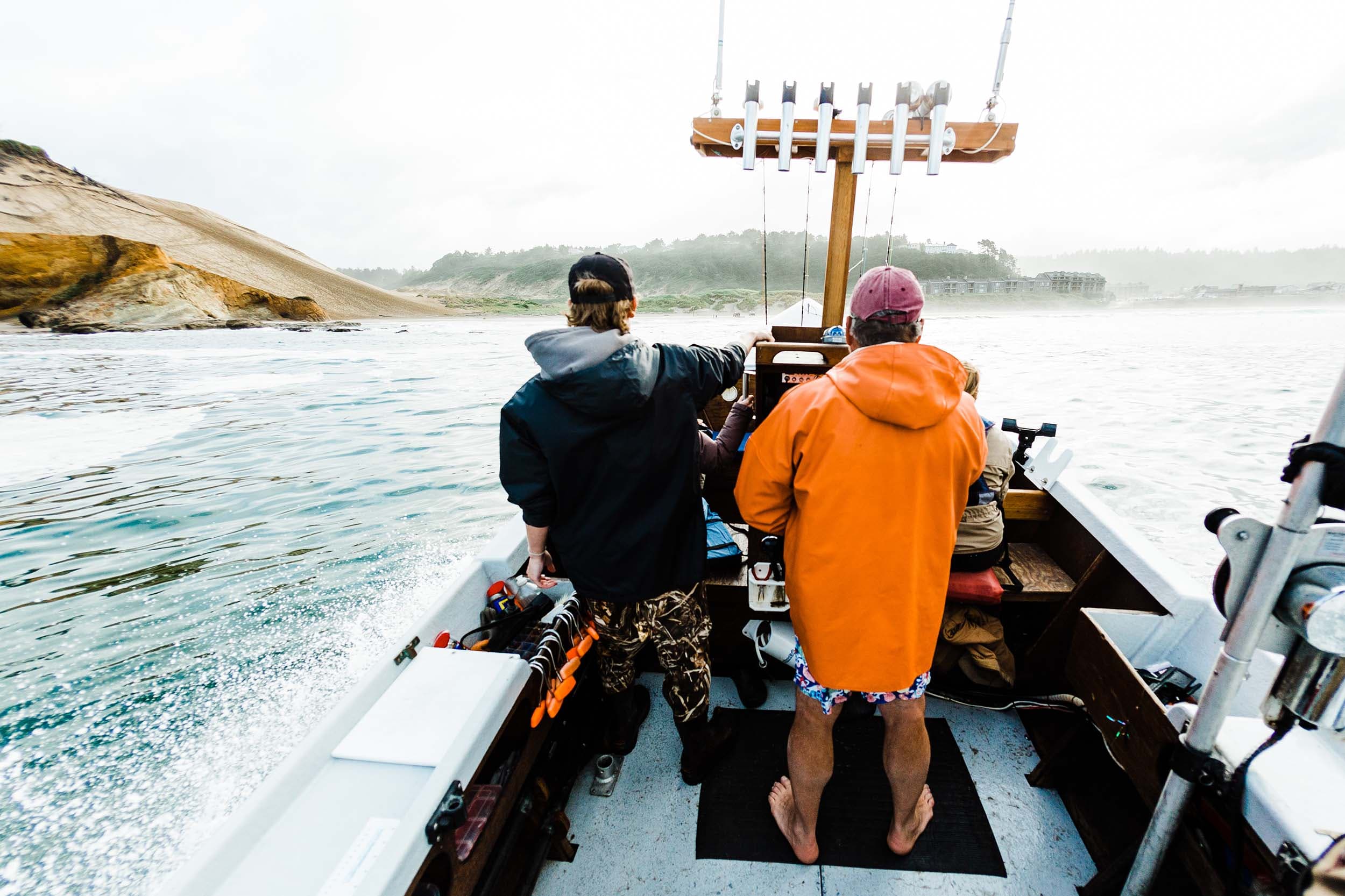 A Dory Fishing boat with 2 people going towards Headlands