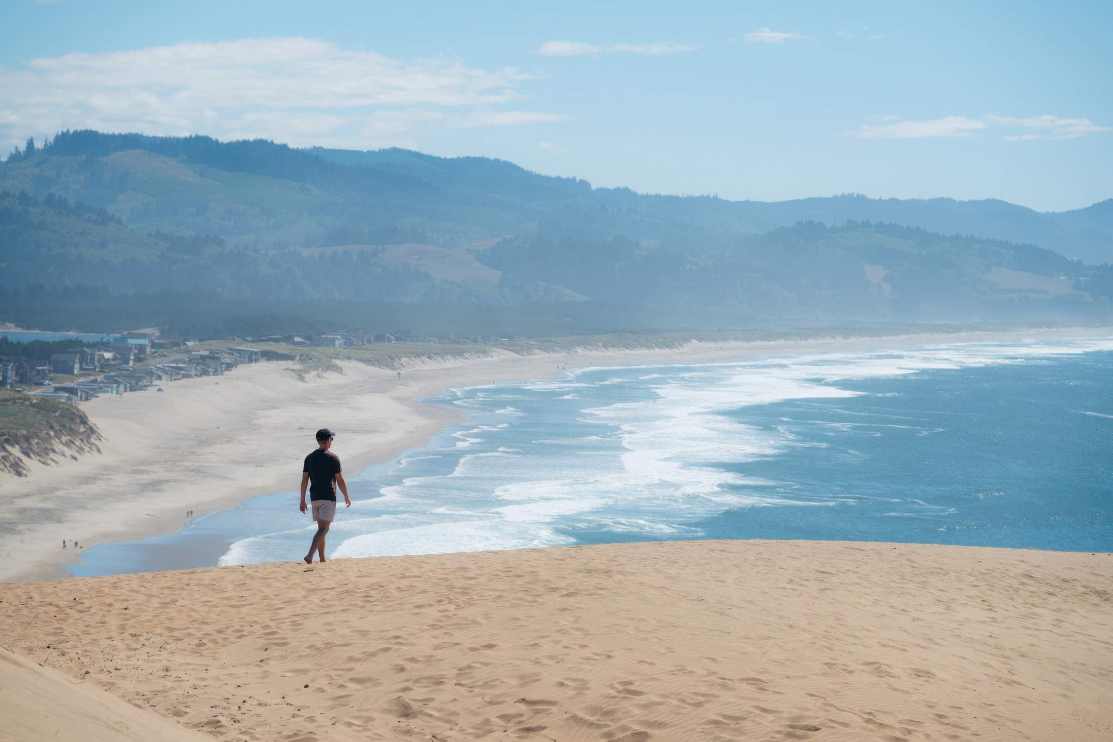 A man hiking on the dunes at Cape Kiwanda