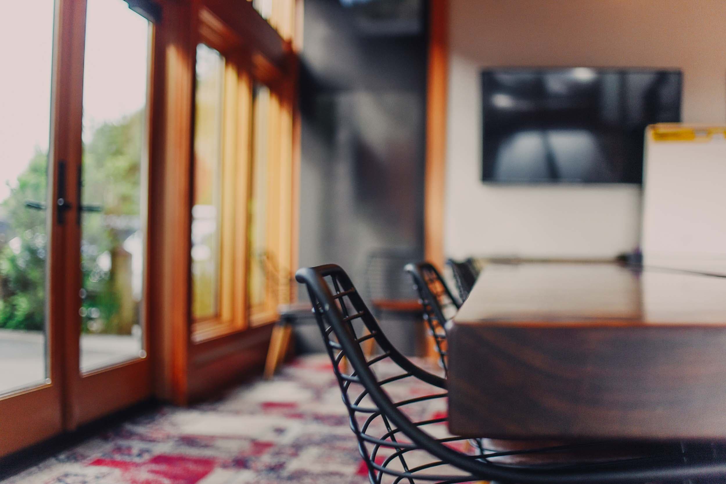 A close up of a table and chair in the Latitude conference space at Headlands