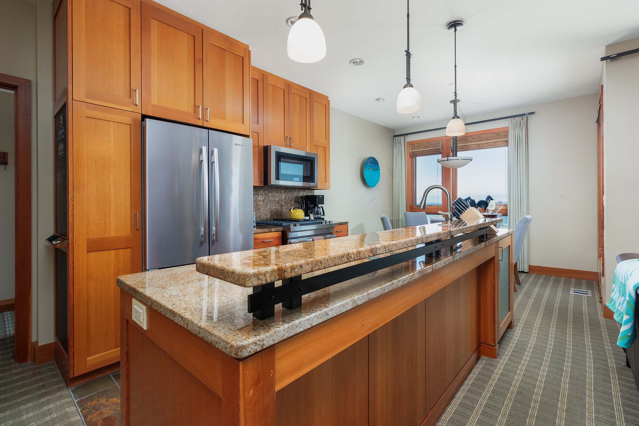 The kitchen with marble counter tops and modern appliances in a 3 bedroom cottage at Headlands