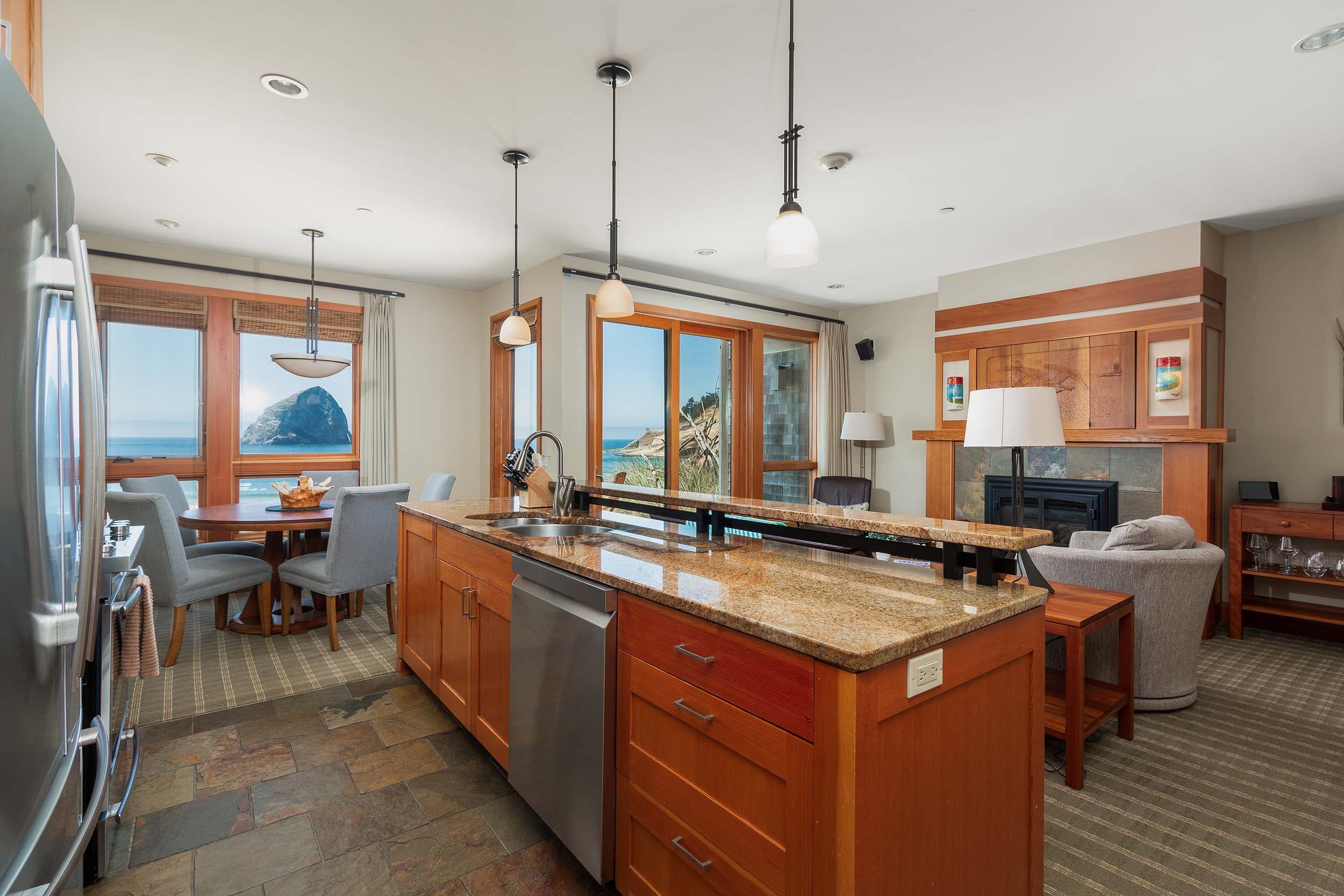 The kitchen with marble counter tops and modern appliances in a 3 bedroom grand cottage at Headlands