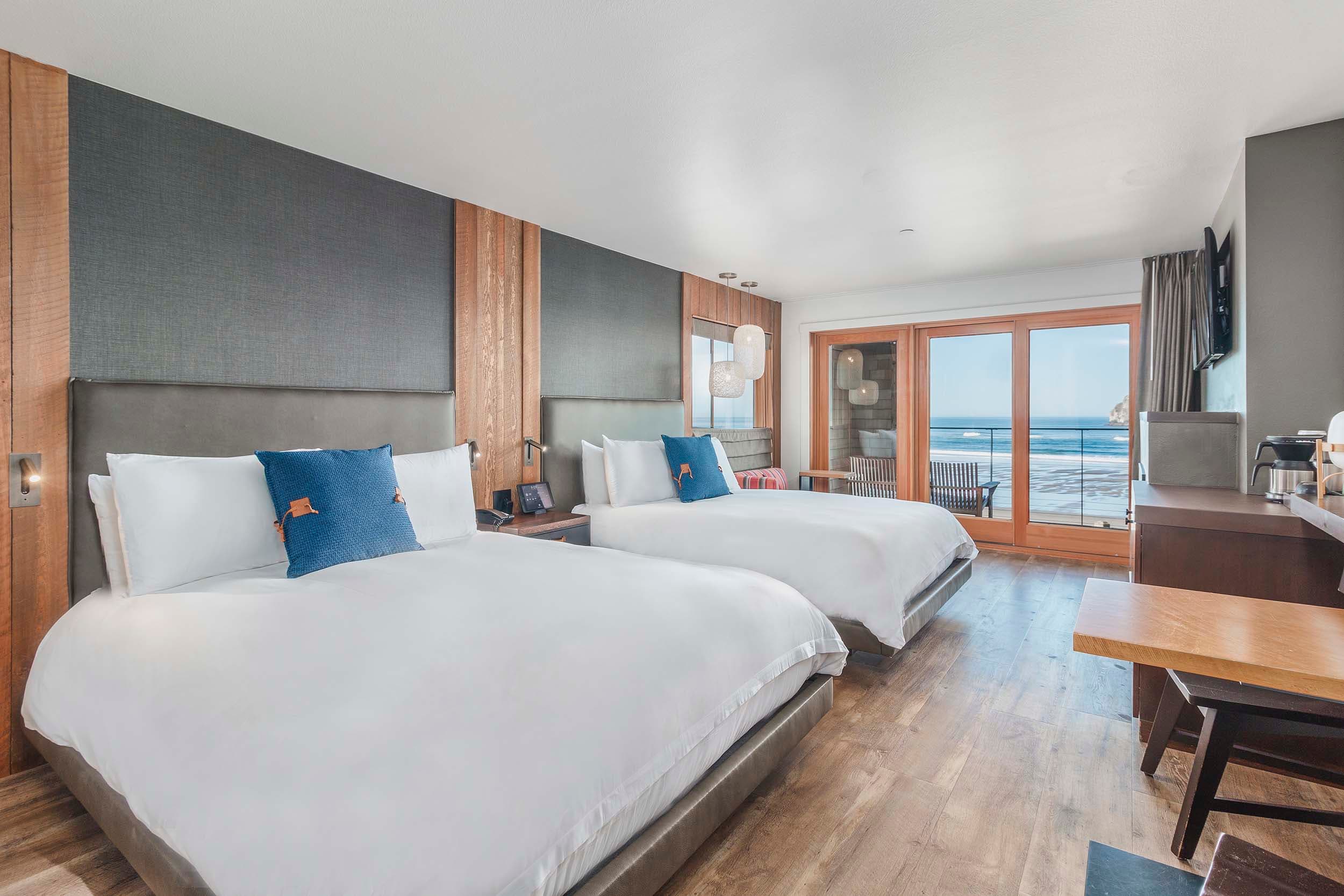 A fully equipped room with a view of the ocean and Haystack rock from a Two Queens Sunlight lodge at Headlands