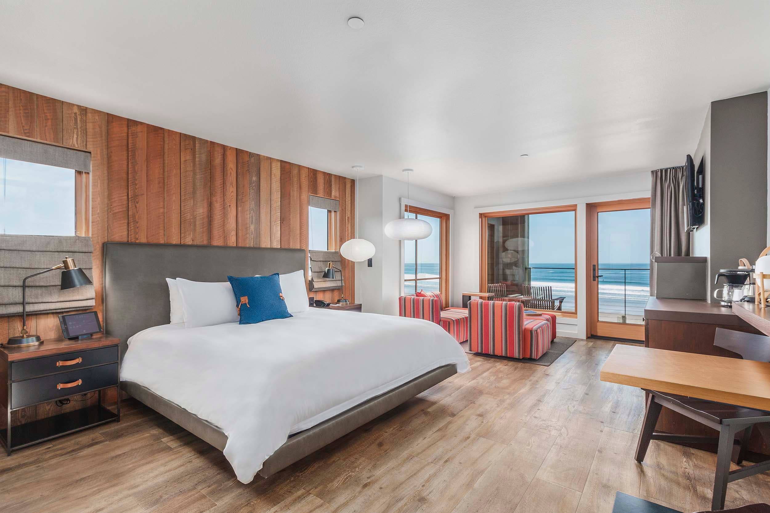 A king bed, desk, and lounge area in a King Sunlight Accessible room at Headlands