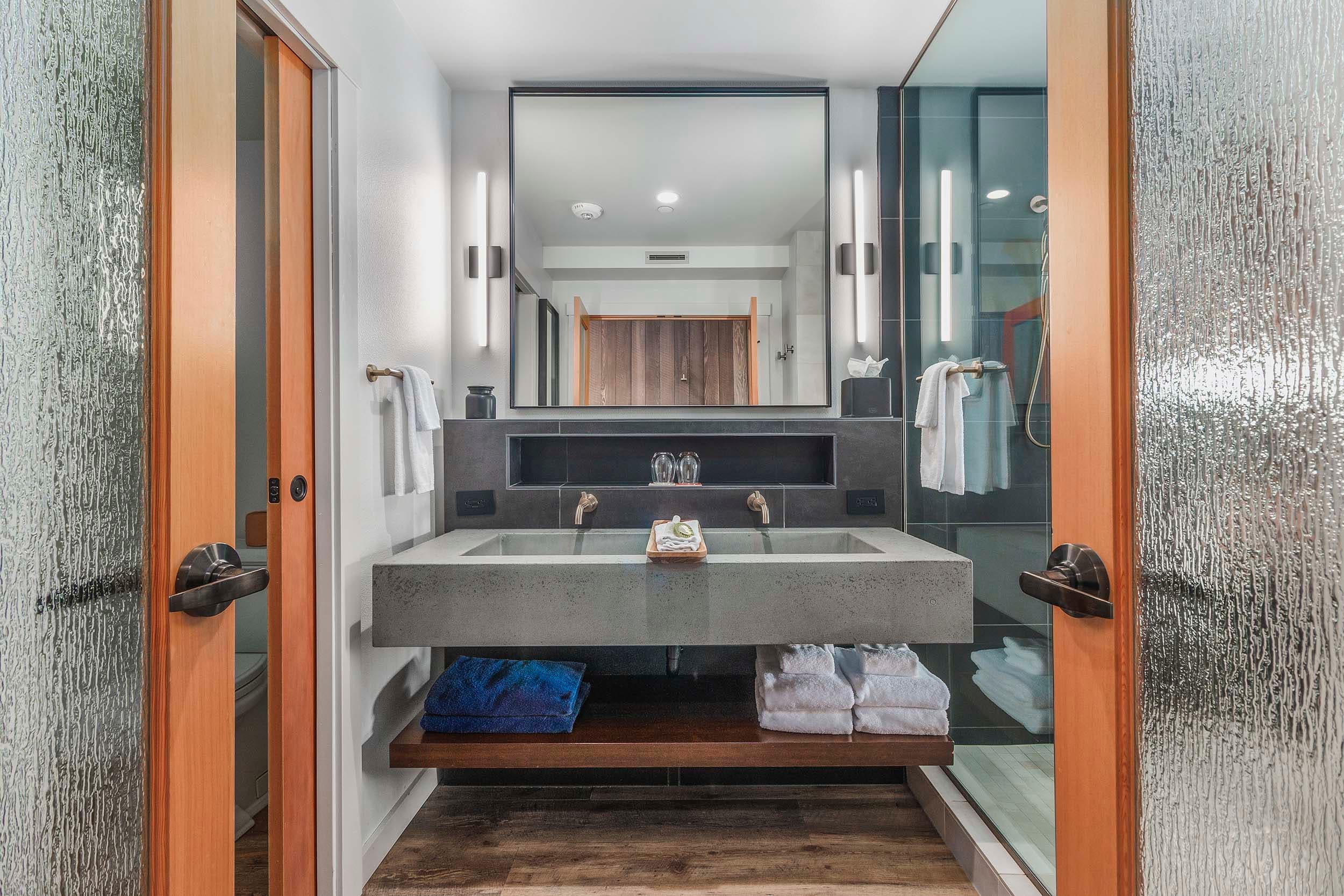 A modern bathroom with bright lighting in a King Sunlight Top Floor at Headlands