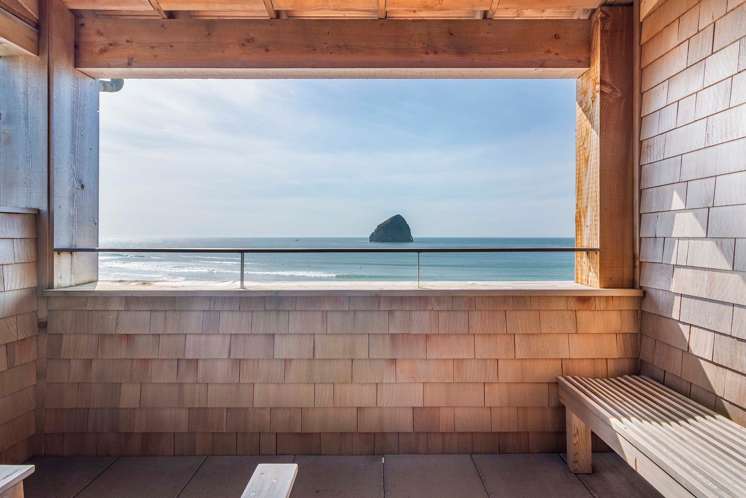 A balcony with a view of Haystack rock from a Corner King Sunlight Top Floor at Headlands