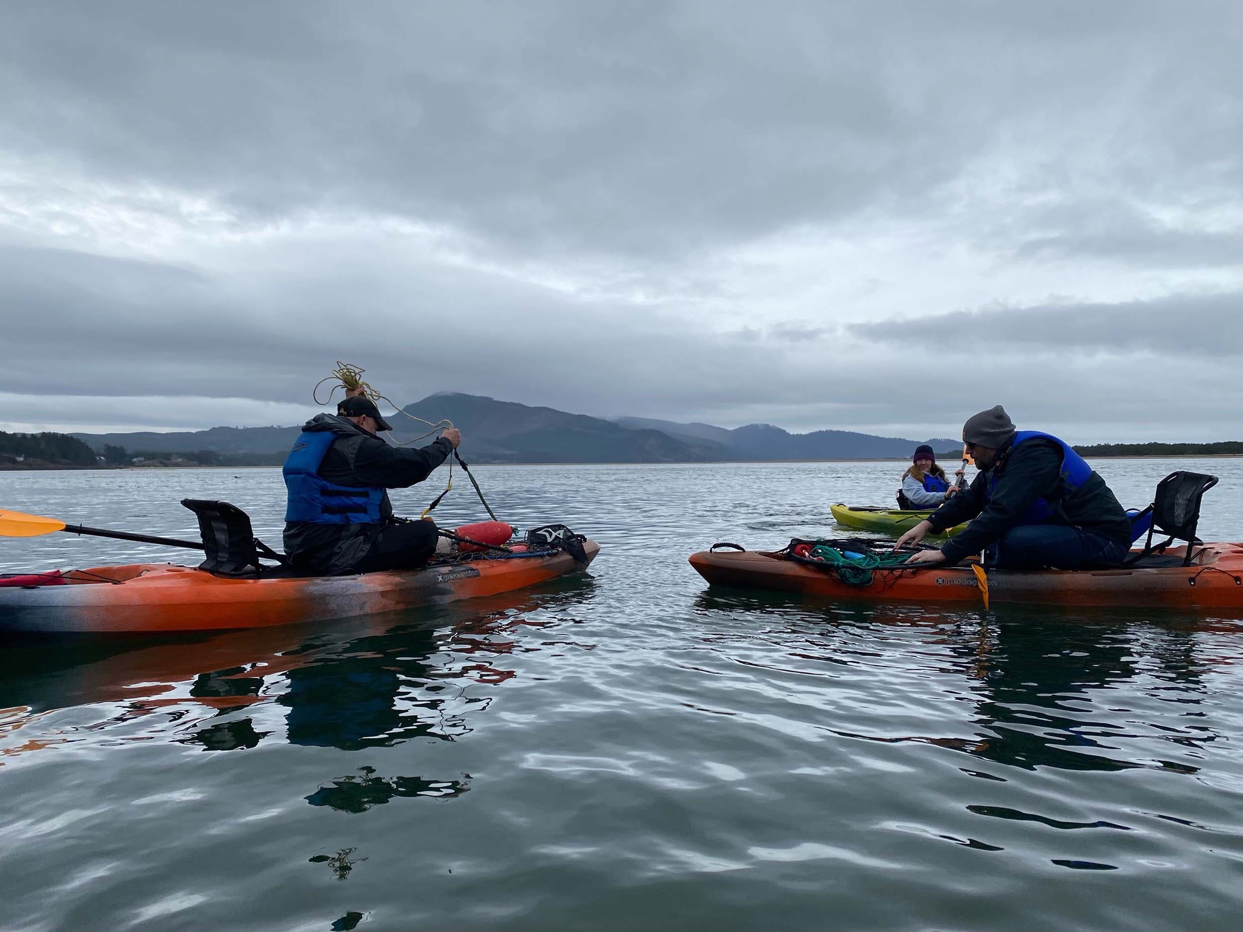 3 people crabbing in kayaks near Headlands