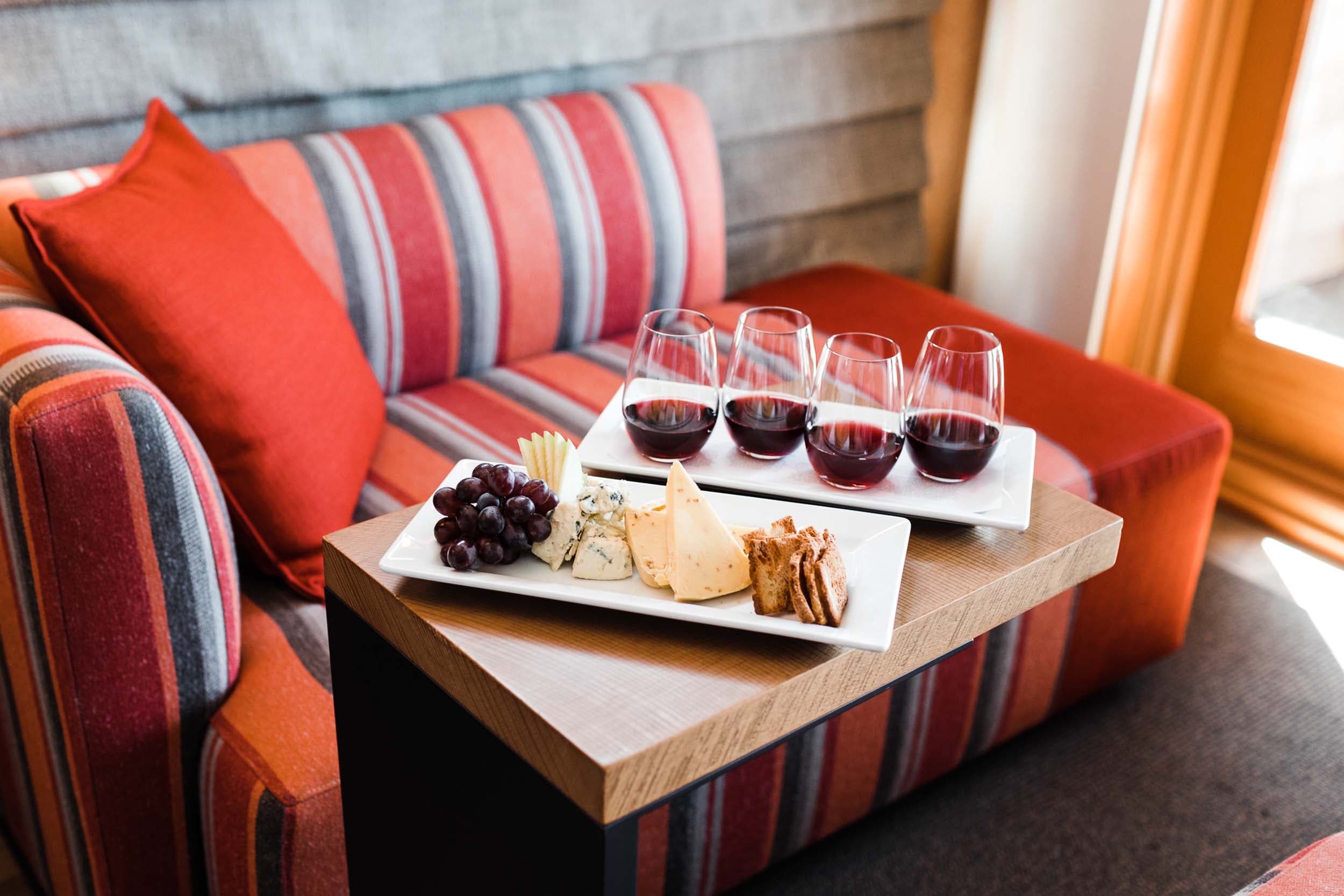 A rectangle plate with 4 tasting sized glasses of red wine and a cheese and cracker plate at Headlands