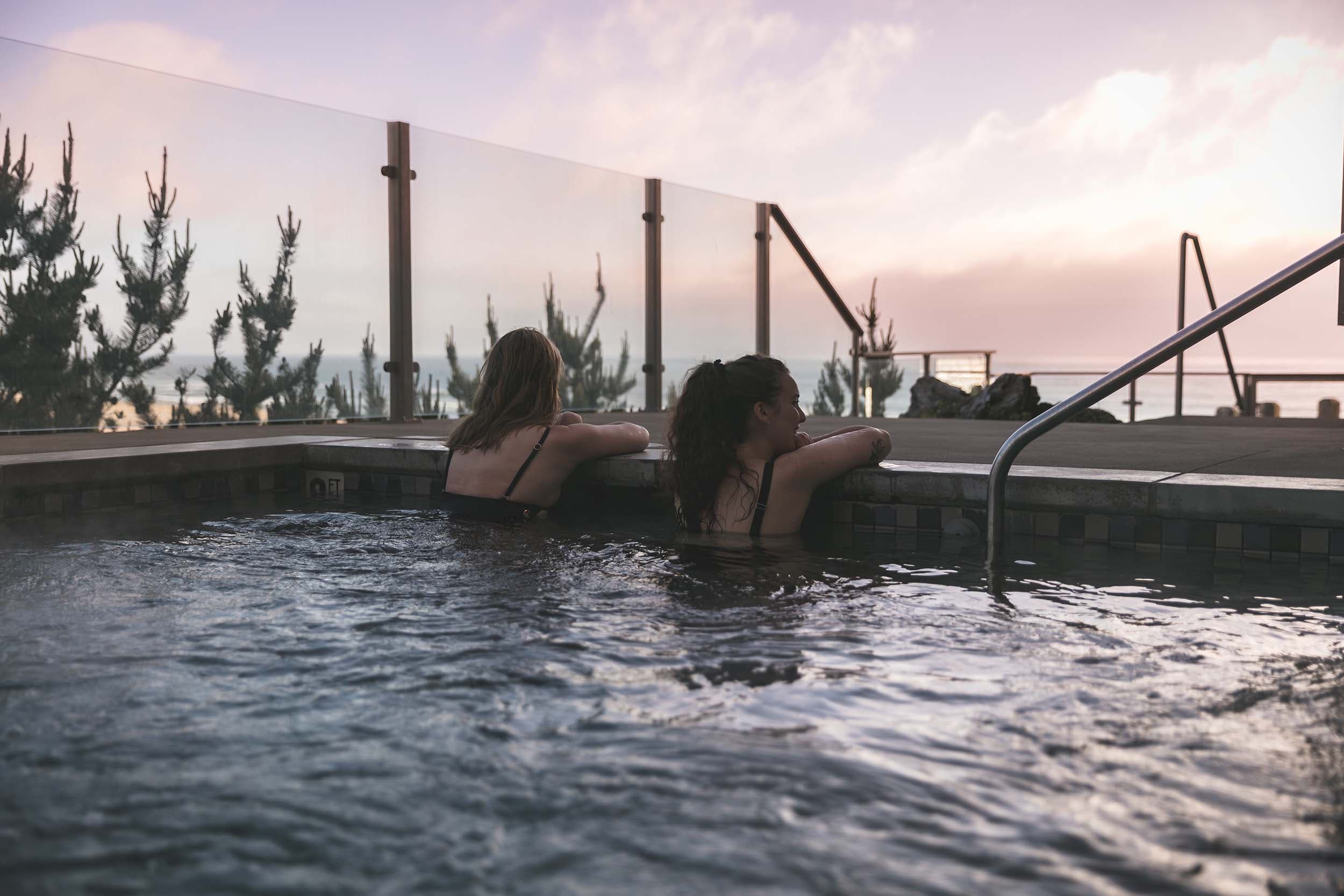 Two women in the outdoor hot tub at Headlands