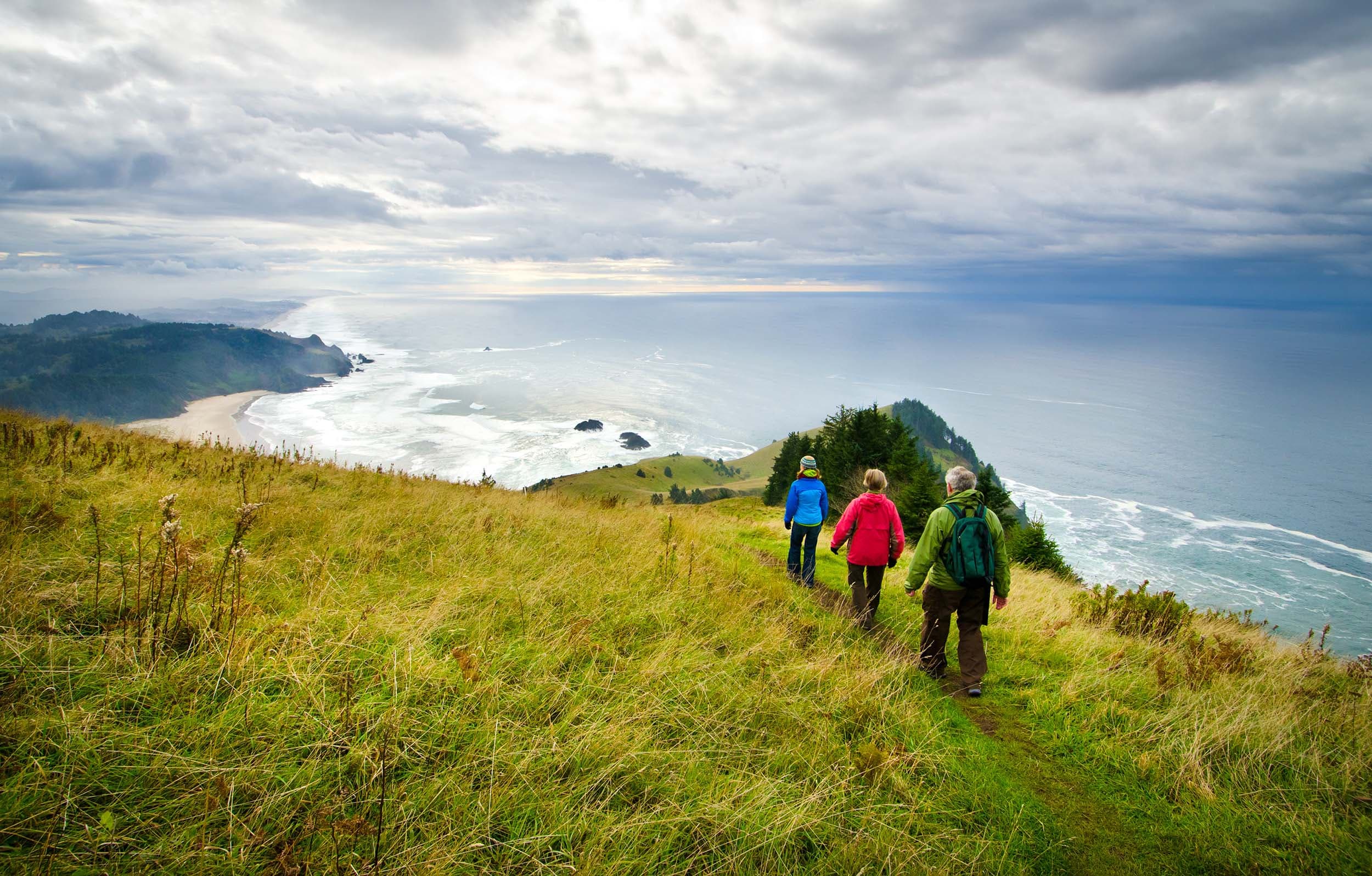 Three hikers at Cascade Head on the Oregon Coast.