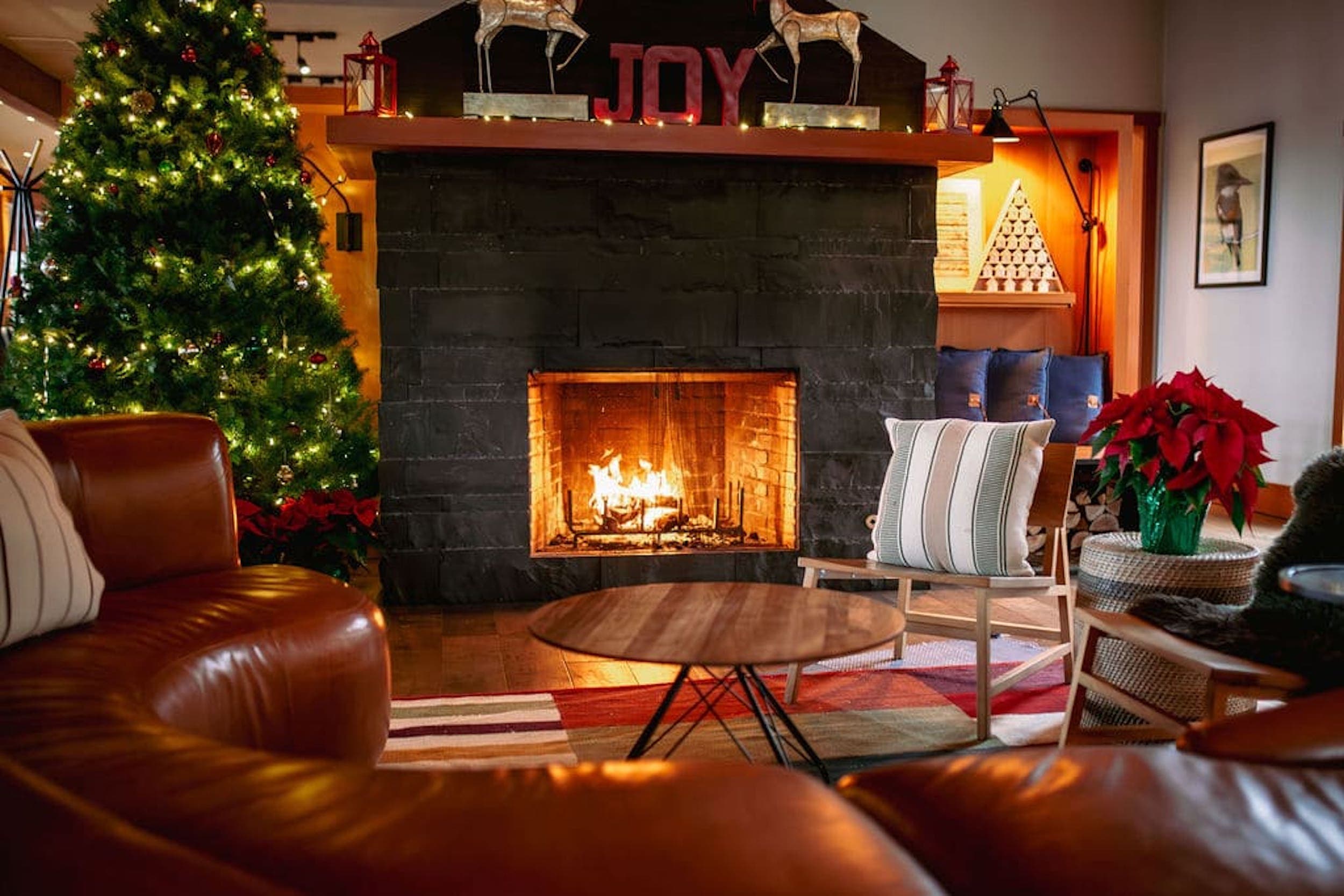 The lounge area of Headlands with the fireplace going and the area decorated for Christmas