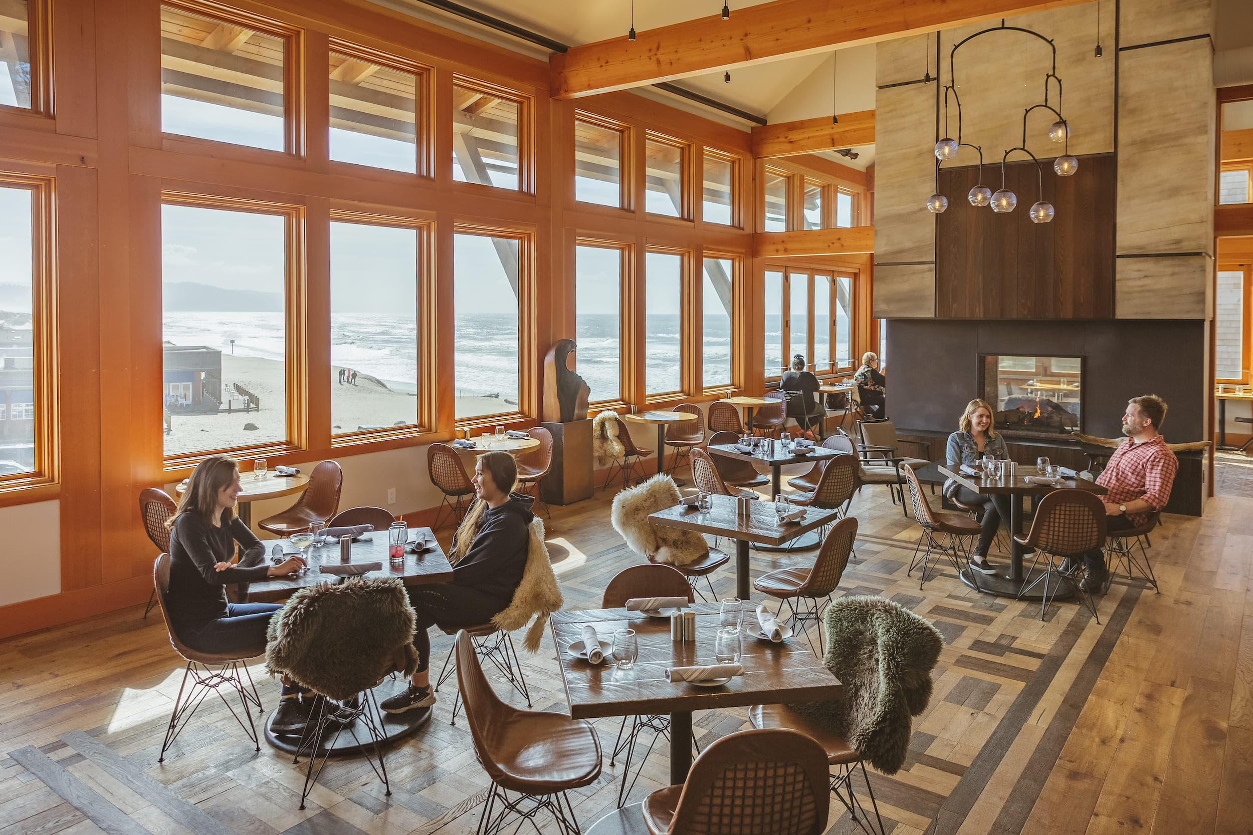 Meridian Restaurant & Bar dining room with people having drinks by the fireplace