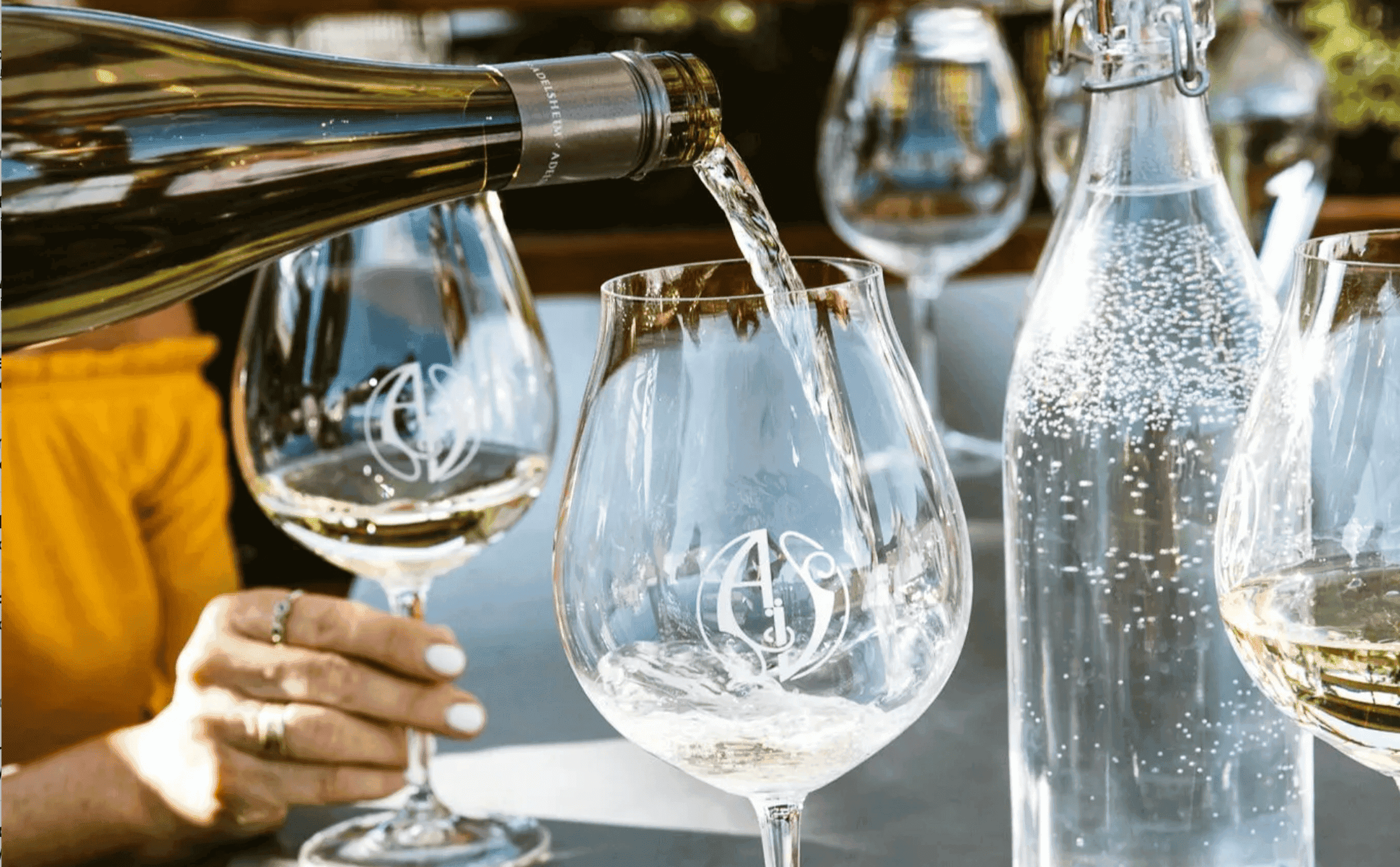 White wine being poured into a wine glass at a table at Meridian Restaurant & Bar
