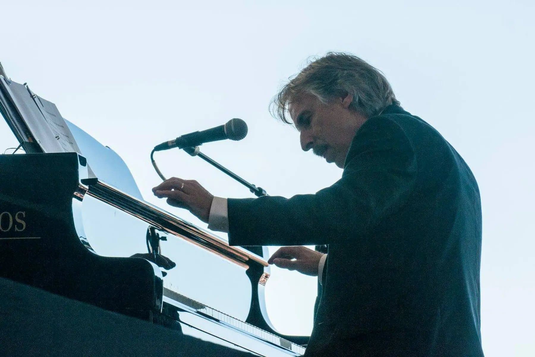 John Nilsen playing a piano on stage